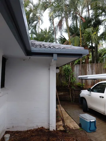 A work ute parked at a white rendered home